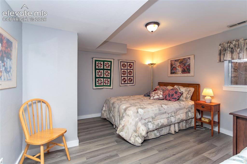 Image 33 of 50: Fifth Bedroom is on Basement Level and has Laminate Flooring