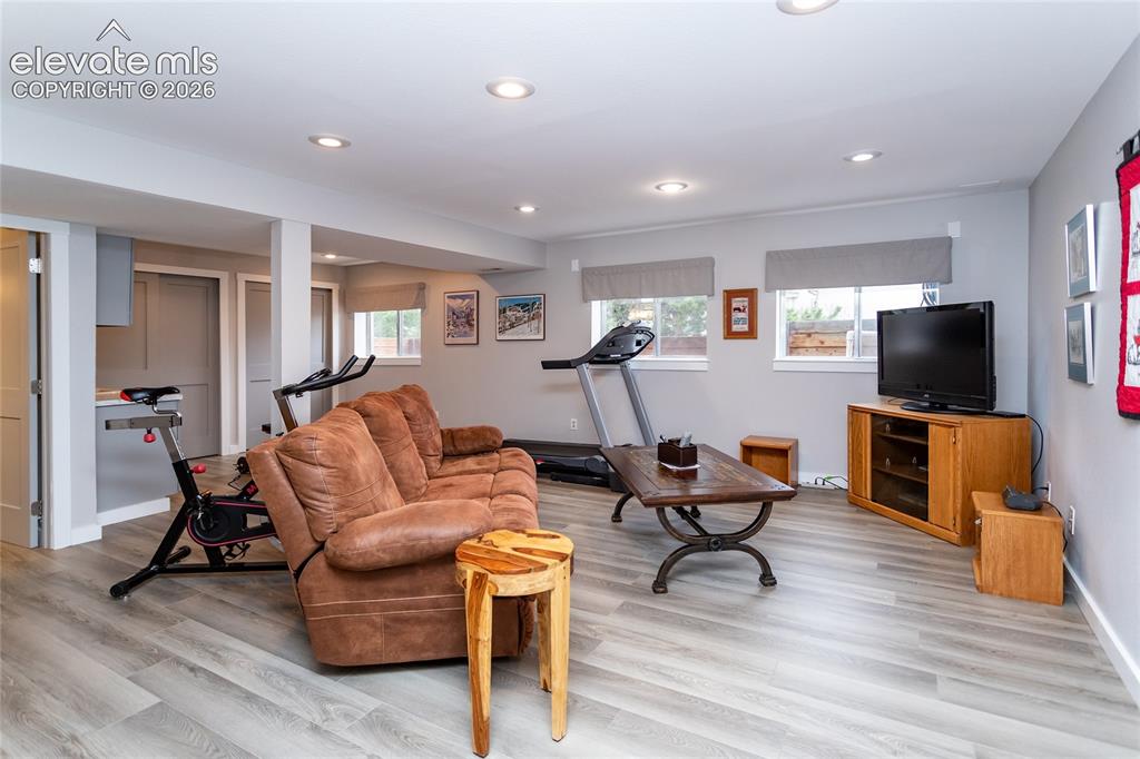Image 35 of 50: Huge Basement Recreation Room has laminate Flooring and Garden Level Window