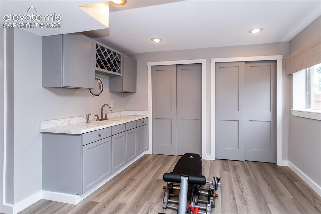 Image 36 of 50: Workout Nook has plenty of Storage and convenient Wet Bar