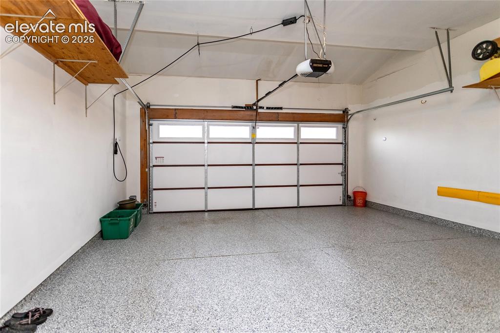 Image 38 of 50: Fully Finished Garage Parking Area w/ Shining Epoxy Flooring and plenty of