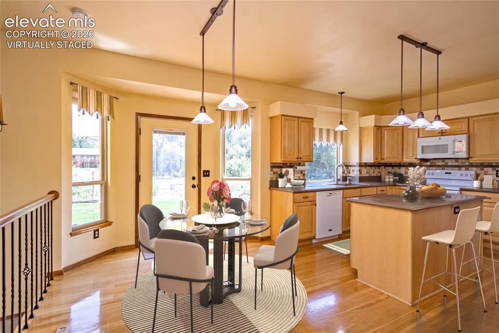 Image 5 of 50: Virtually Staged: Kitchen Nook has Bay Window/ Door and walks-out to the Pa