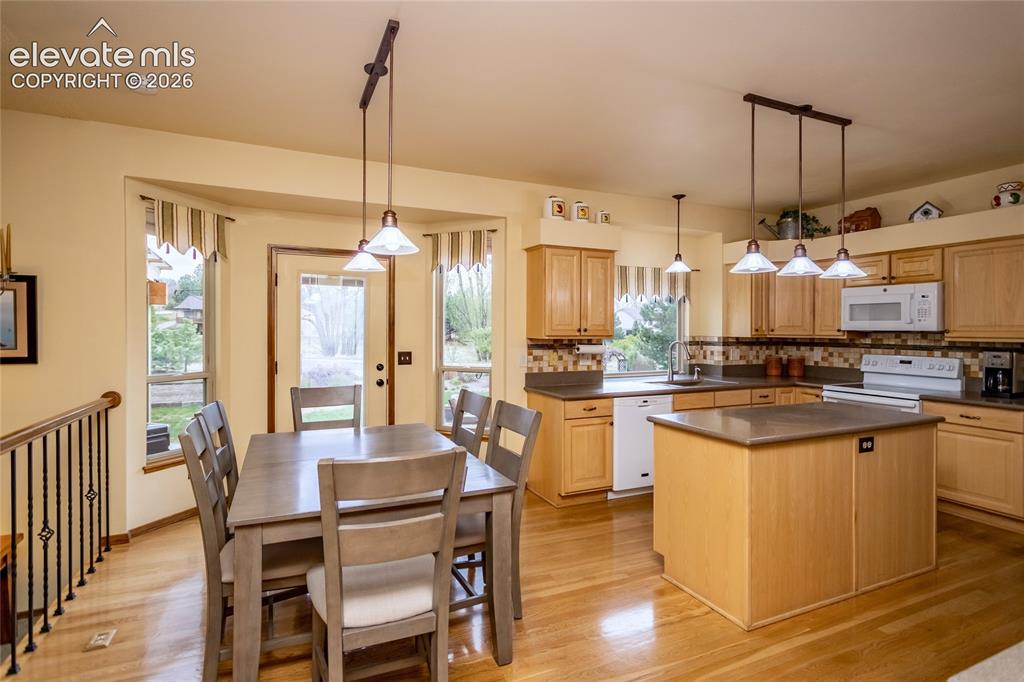 Image 7 of 50: Kitchen adjoins the Family Room and has Wardwood Floors and Solid Man-made