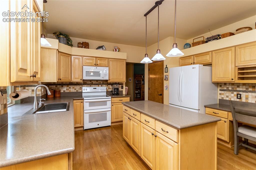 Image 9 of 50: Kitchen features Double Glasstop electris Range/Oven, Refrigerator, Disposa