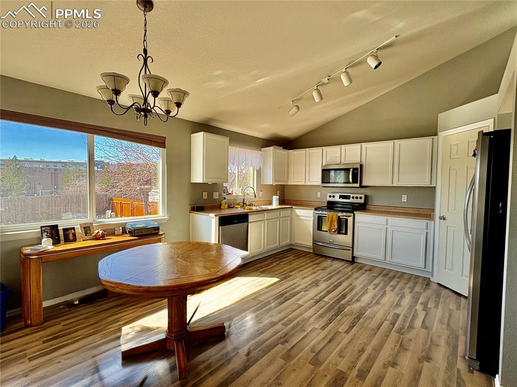 Image 2 of 11: Bright and spacious kitchen with LVP flooring