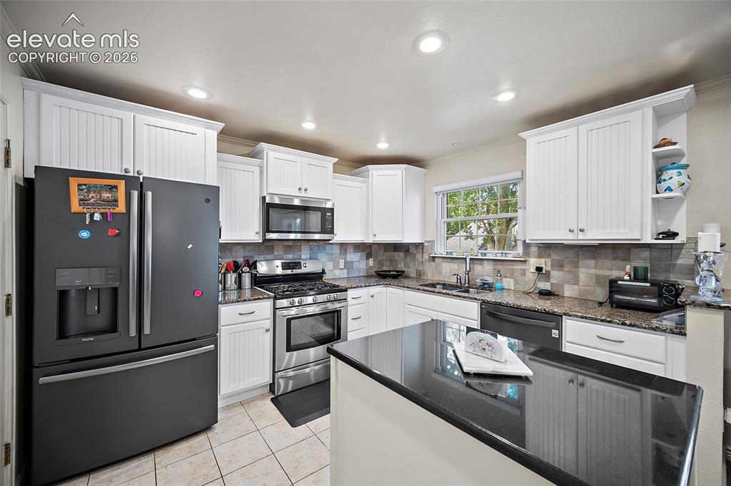 Image 15 of 48: Tons of cabinets and granite countertops.