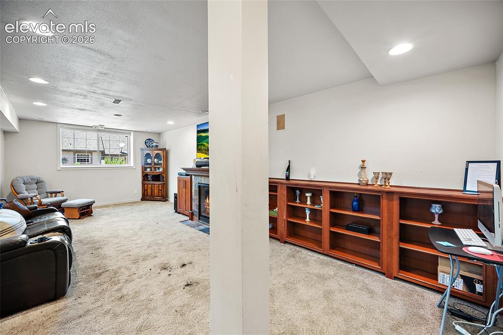Image 30 of 48: Lower-Level family room with large open floor plan.