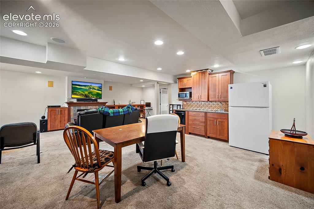 Image 35 of 48: Wet bar and full Refrigerator