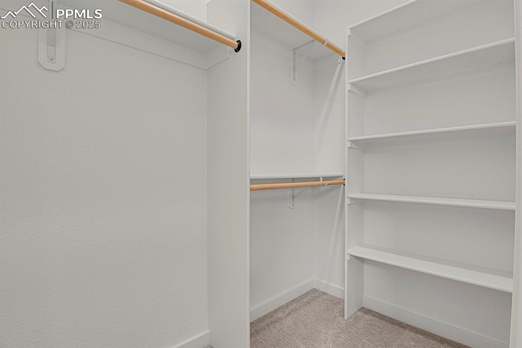 Image 22 of 49: Upper level suite walk-in closet