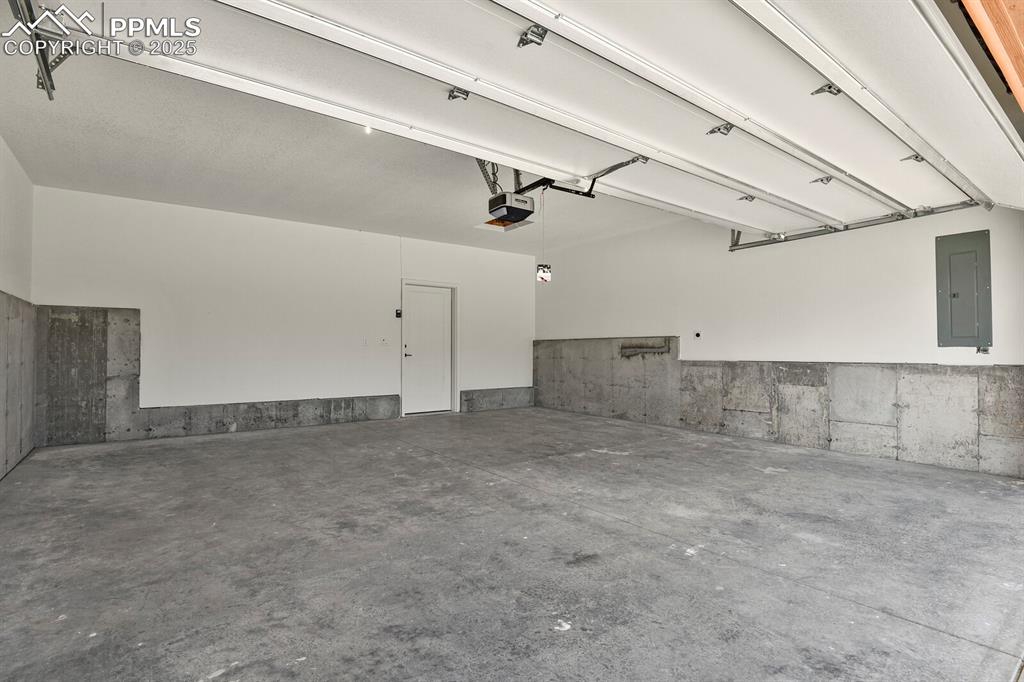 Image 30 of 49: Two car attached garage includes 220v service for electric car charging