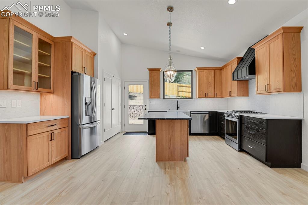 Image 8 of 49: Full suite of LG stainless appliances including gas range and custom fabric