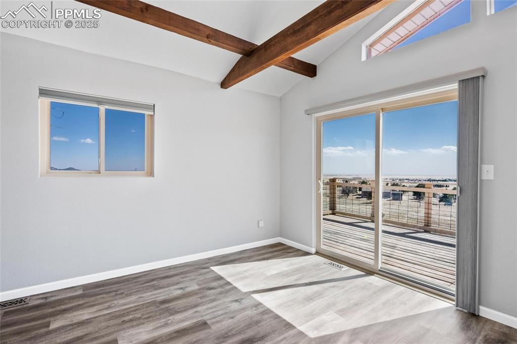Image 11 of 38: Spare room with wood finished floors and baseboards