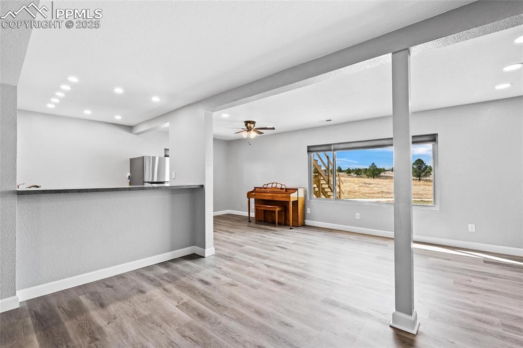 Image 18 of 38: Living room featuring recessed lighting, wood finished floors, a ceiling fa