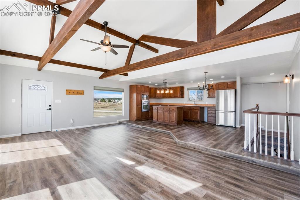 Image 5 of 38: Unfurnished living room featuring a chandelier, recessed lighting, a sink, 