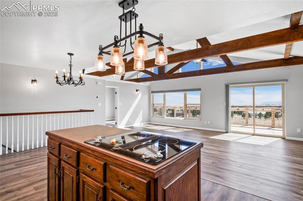 Image 8 of 38: Kitchen featuring open floor plan, a chandelier, dark wood-type flooring, b