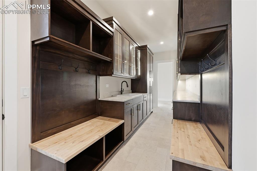 Image 18 of 45: Kitchen Galley with prep sink, benches with storage.