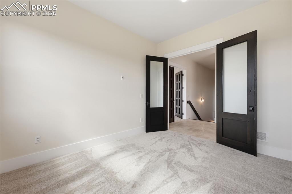 Image 19 of 45: Office looking back to downstairs and Master Bedroom Suite to the left.