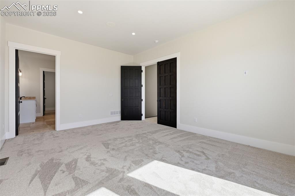 Image 20 of 45: Master Bedroom Suite looking into Bath area and entry from hallway. Note: s