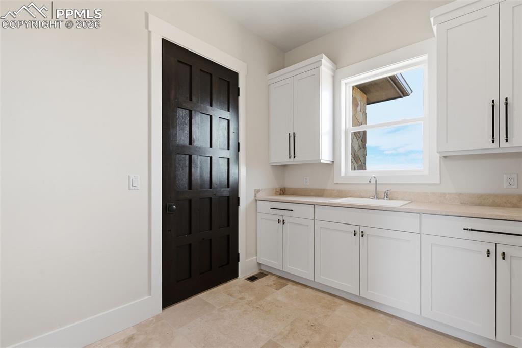 Image 23 of 45: Laundry Room from Master Bedroom Suite.