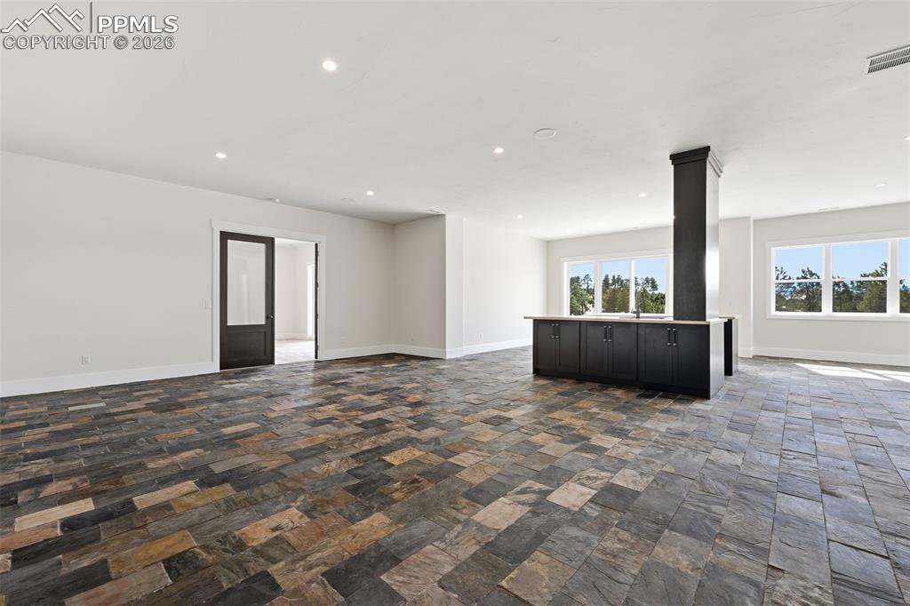 Image 25 of 45: Lower-Level Family Room with wet bar