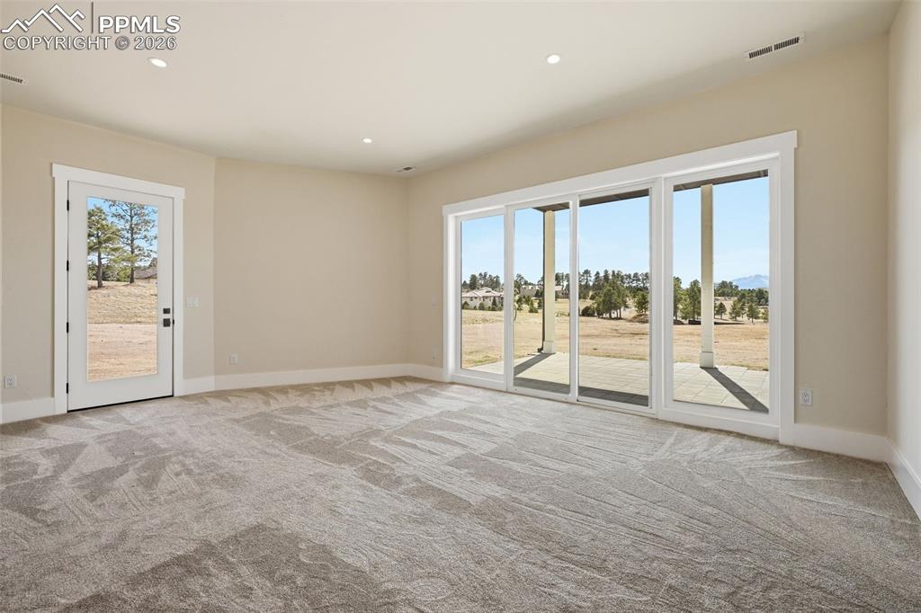 Image 32 of 45: 2nd Bedroom on lower-level showing egress to patios.