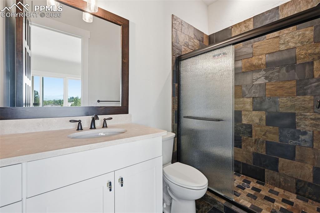 Image 40 of 45: Bathroom with a stall shower and vanity