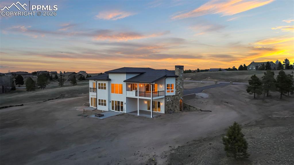 Image 43 of 45: Back of house with a patio, a chimney, and a balcony