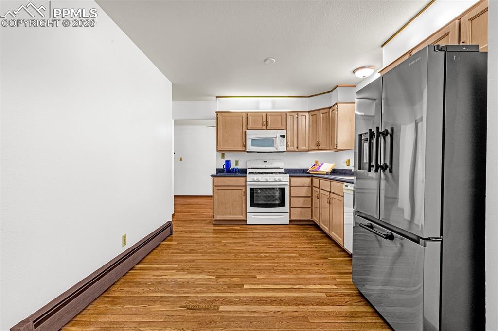 Image 10 of 44: View of the kitchen showing ample space for a kitchen island or breakfast t