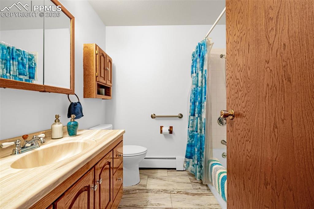 Image 19 of 44: Main floor full bathroom with a vanity, a mirrored medicine cabinet, and a 