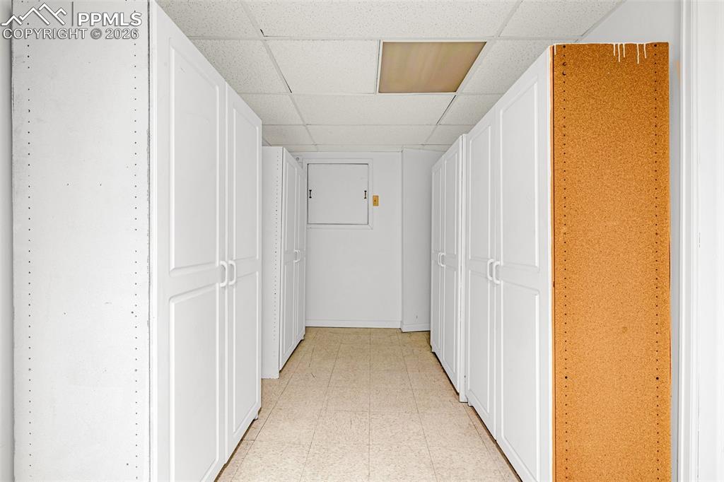 Image 27 of 44: This room features extensive built-in storage with white cabinetry, and a t