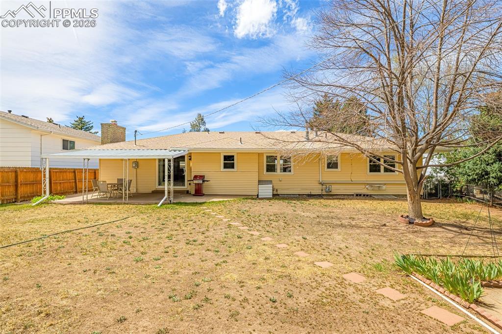 Image 30 of 44: The property features a spacious backyard with a covered patio area, a larg