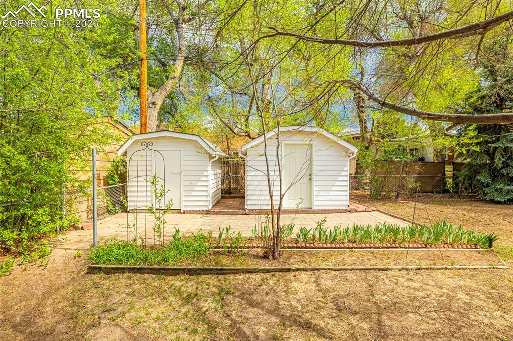 Image 35 of 44: The property features two white sheds, providing additional storage options
