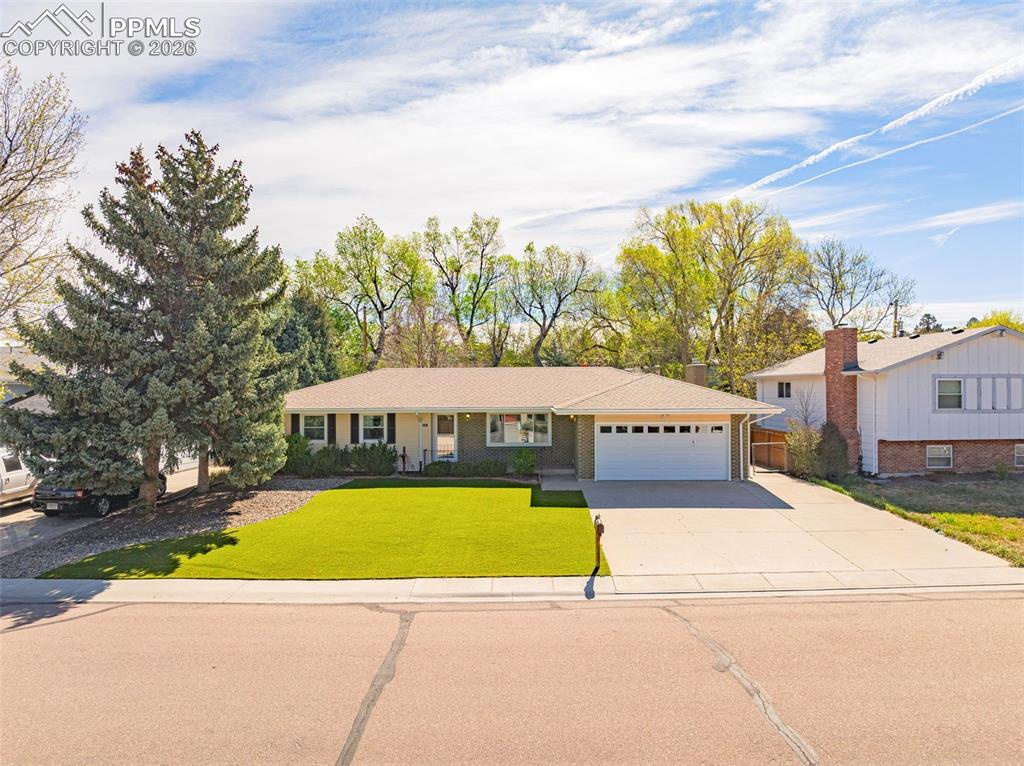 Image 36 of 44: The property features a spacious driveway, and an attached garage