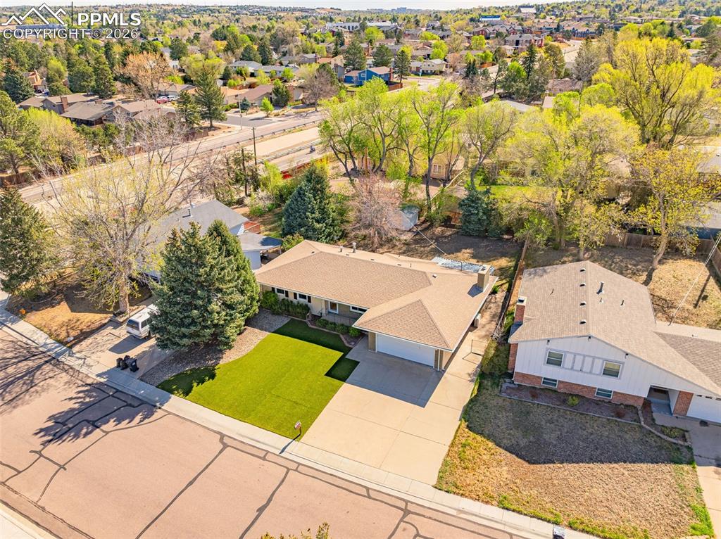 Image 38 of 44: The property features the front lawn and a paved driveway leading to an att