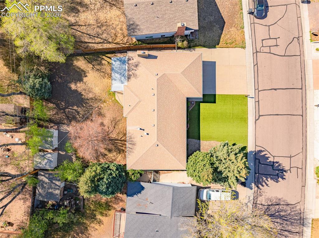 Image 39 of 44: Aerial view of the property showing the main building with a tan shingle ro
