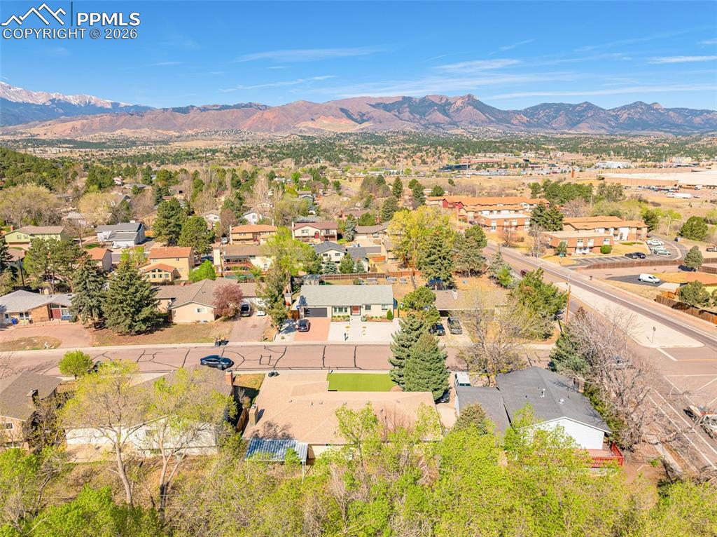 Image 40 of 44: Aerial view showcasing the surrounding neighborhood with distant mountains