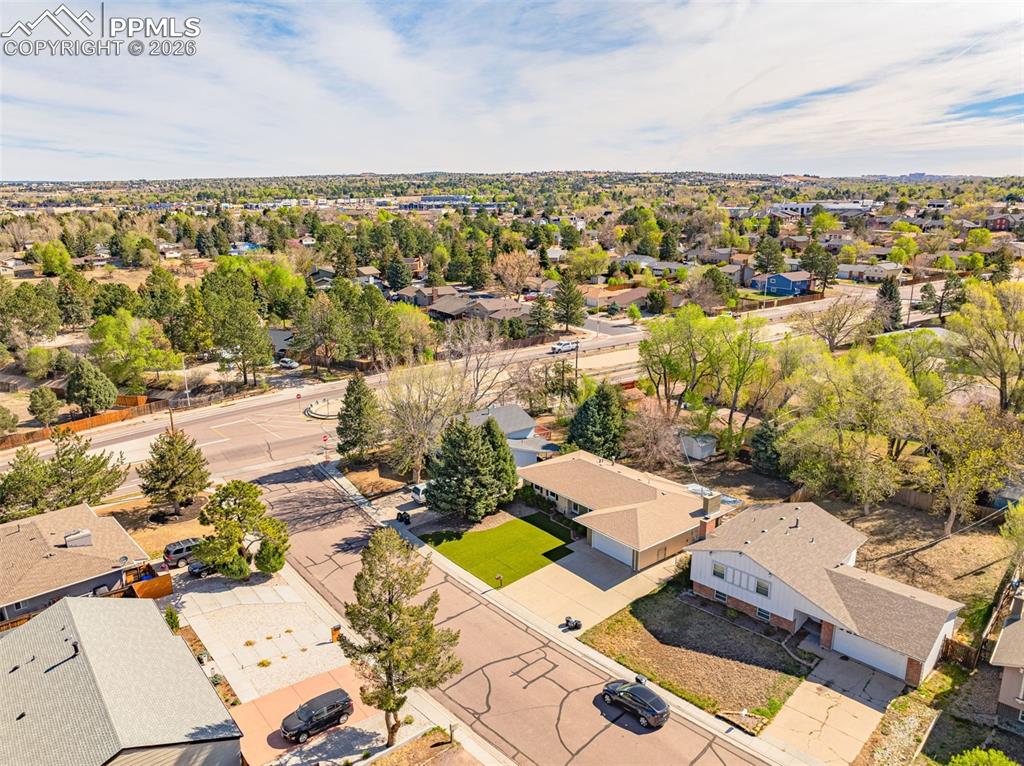 Image 43 of 44: The property features a well-maintained lawn and a paved driveway leading t