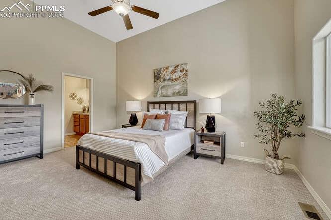 Image 10 of 41: Primary bedroom on the Main level with vaulted ceilings.