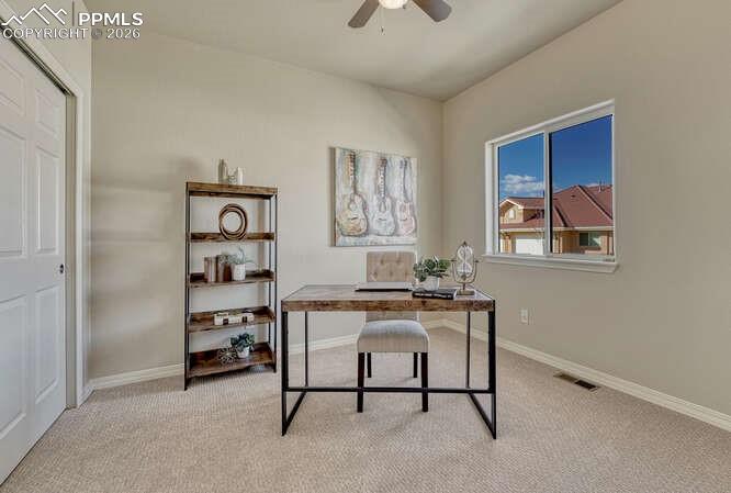 Image 15 of 41: Main level bedroom #2 is located in the front of the house and could be use