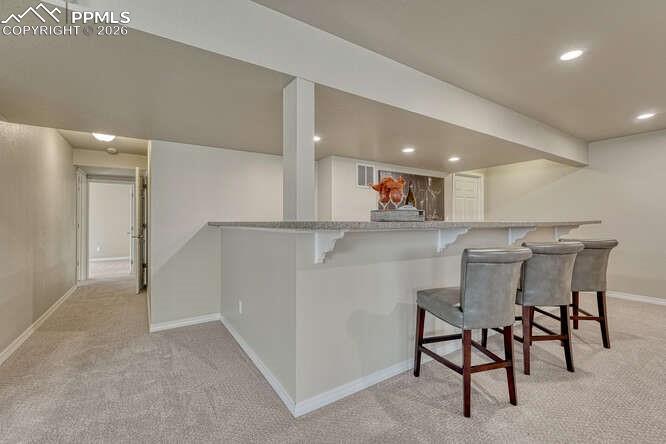 Image 20 of 41: Basement Family room complete with a very large dry bar