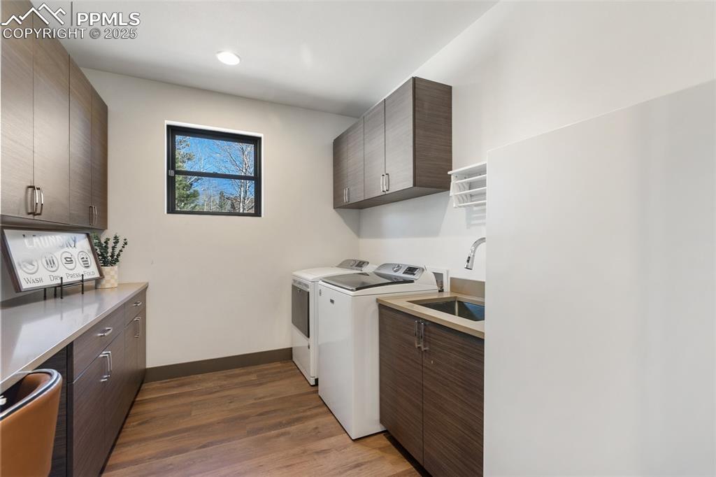 Image 24 of 48: Main floor laundry with pet door access for dog run