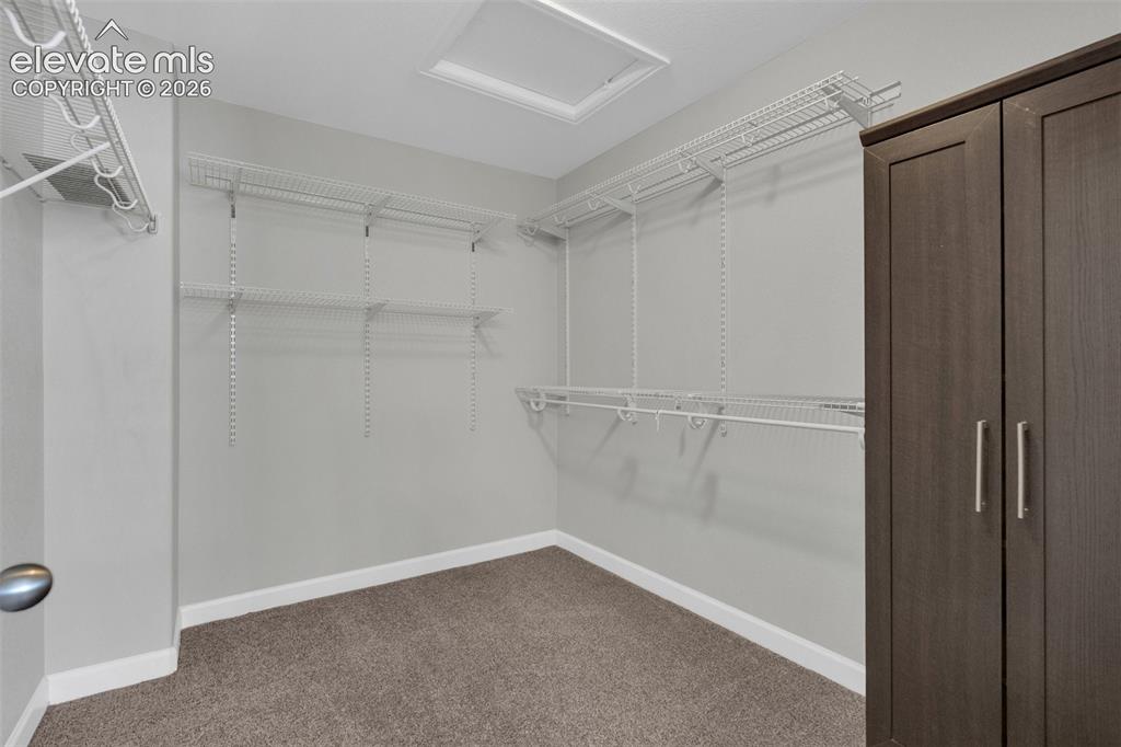 Image 22 of 49: Primary closet. 