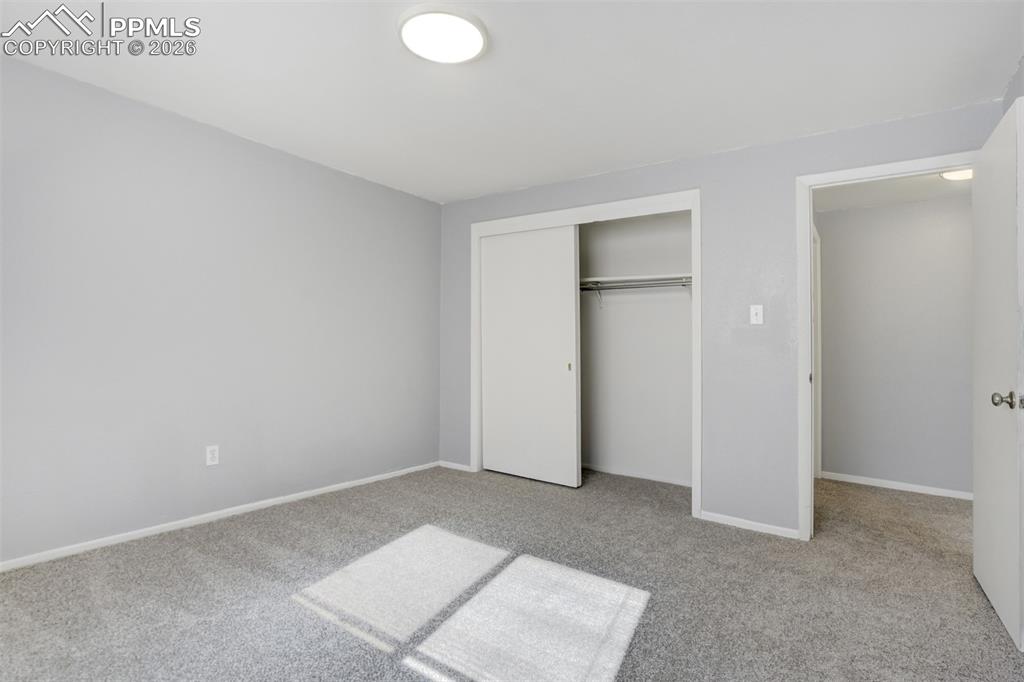 Image 21 of 42: Unfurnished bedroom featuring light carpet and a closet