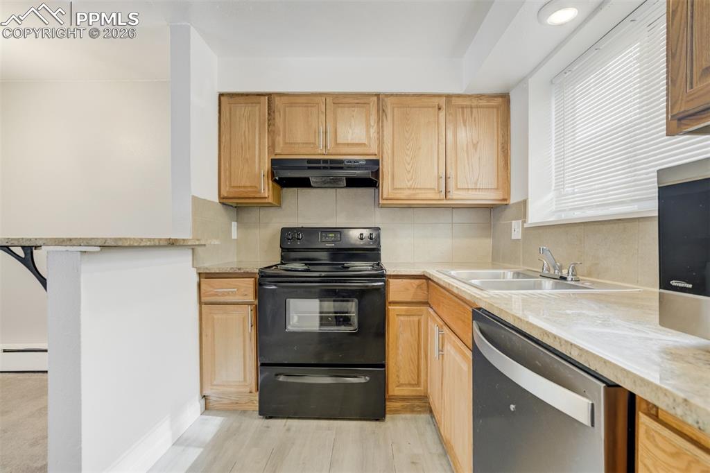 Image 32 of 42: Kitchen with black electric range oven, dishwasher, backsplash, and light s