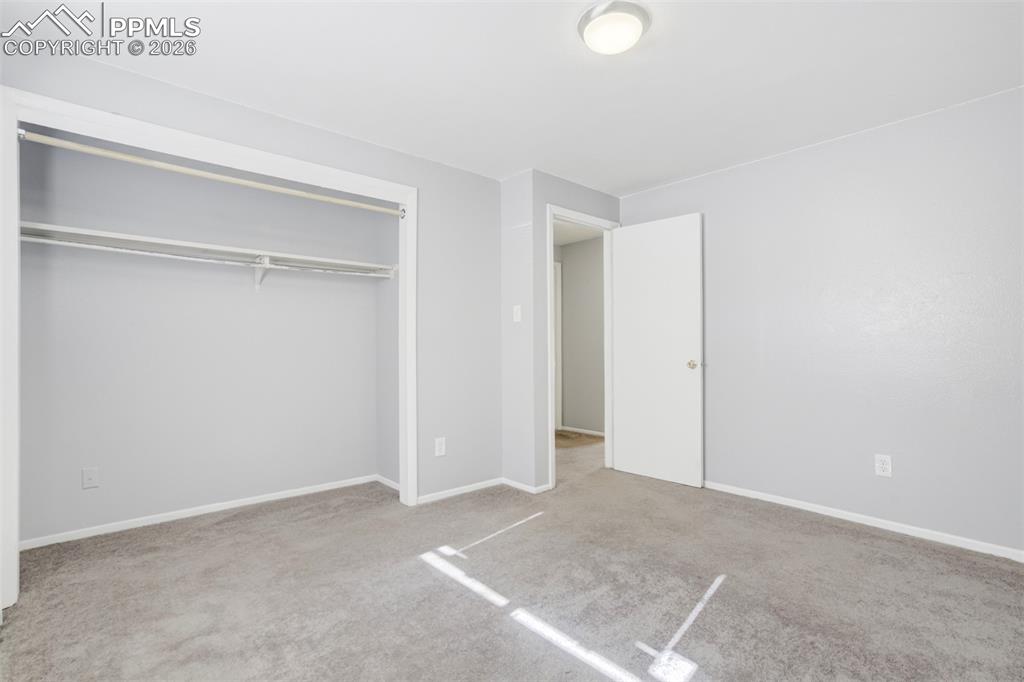 Image 35 of 42: Unfurnished bedroom featuring light carpet and a closet