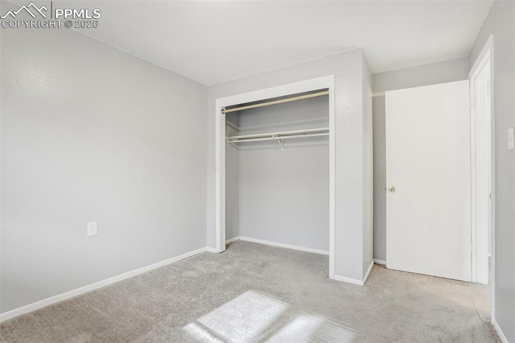 Image 38 of 42: Unfurnished bedroom with light colored carpet and a closet