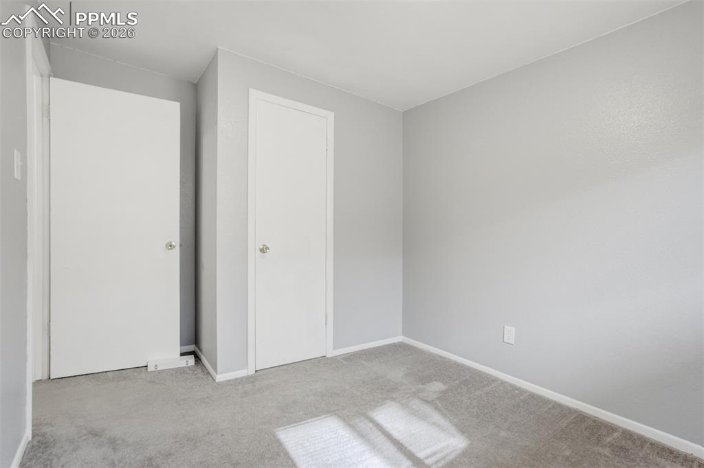 Image 41 of 42: Unfurnished bedroom featuring light colored carpet and a closet