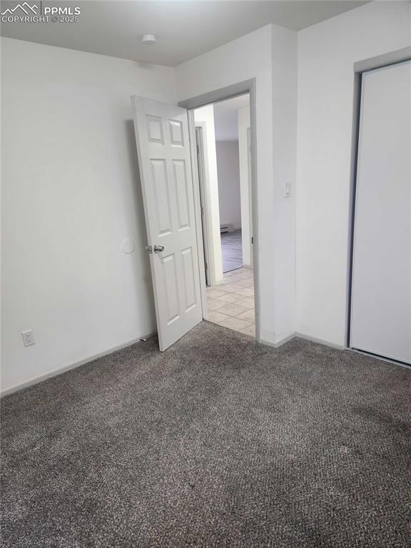 Image 10 of 13: Unfurnished room featuring light colored carpet and light tile patterned fl