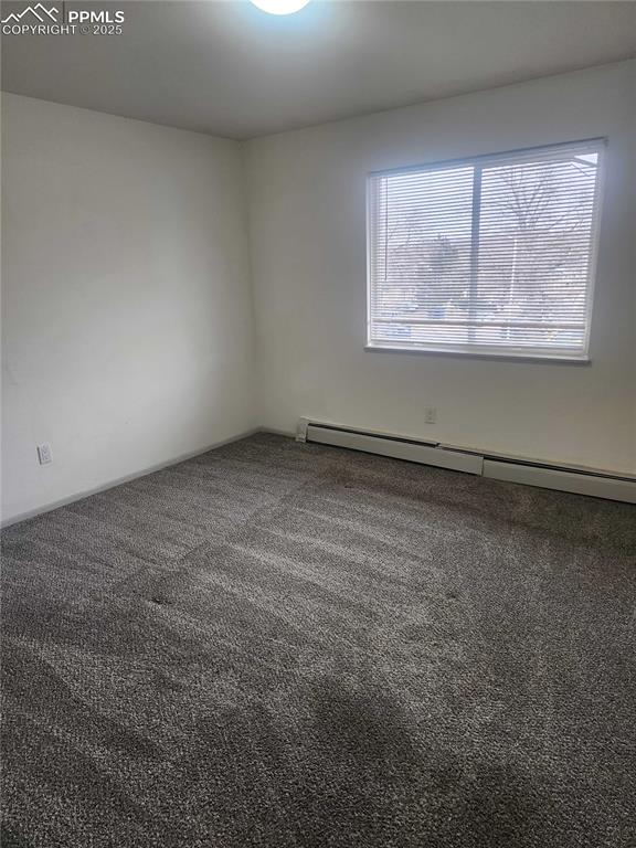 Image 11 of 13: Carpeted spare room with baseboard heating