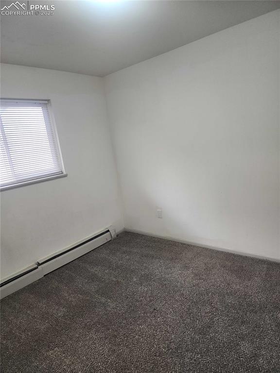 Image 12 of 13: Carpeted spare room with a baseboard radiator