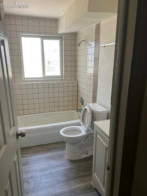 Image 5 of 13: Full bathroom featuring shower / bath combination, vanity, dark wood-style